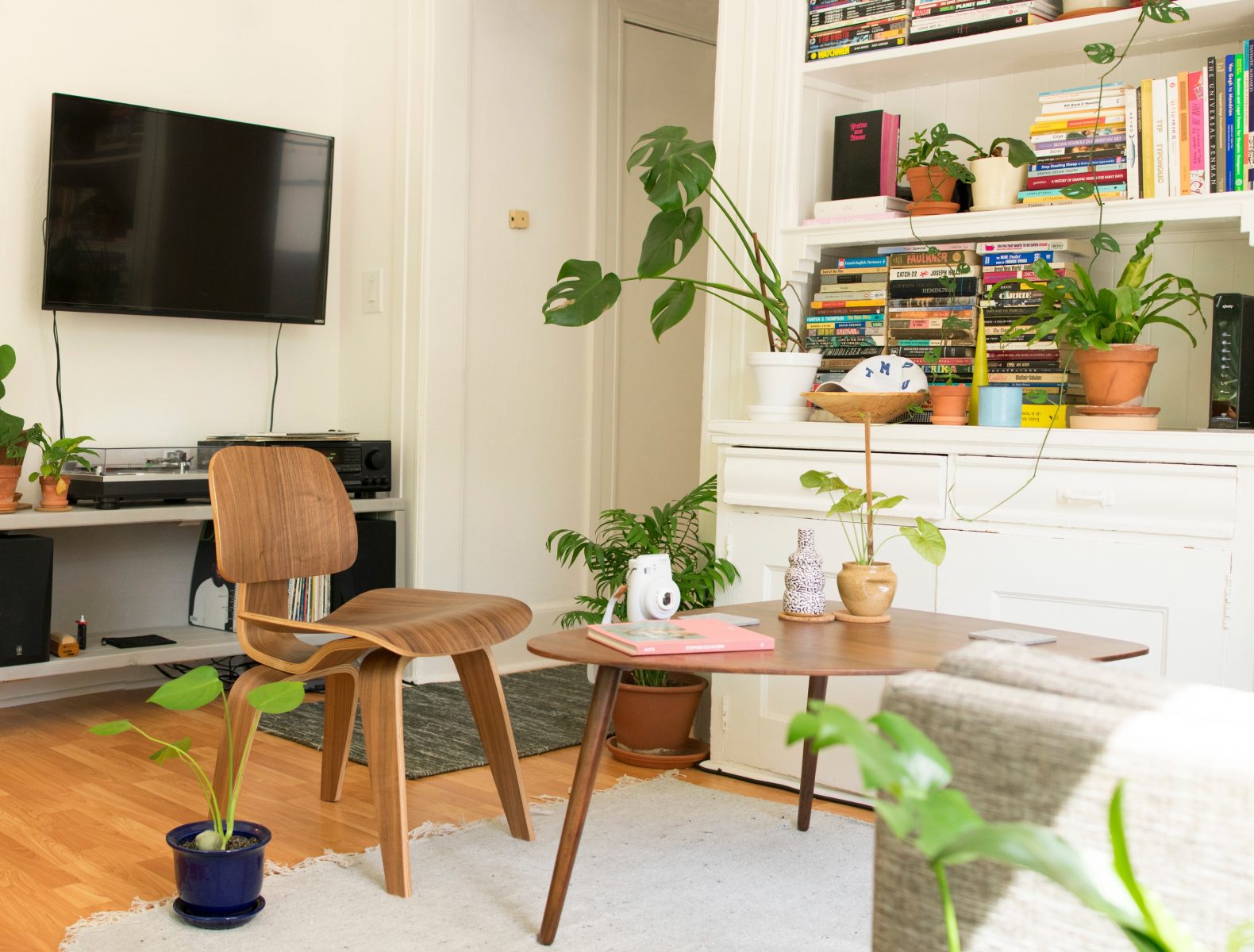 photo of living area with wooden furniture, white cabinet and carpet - home renovation tips