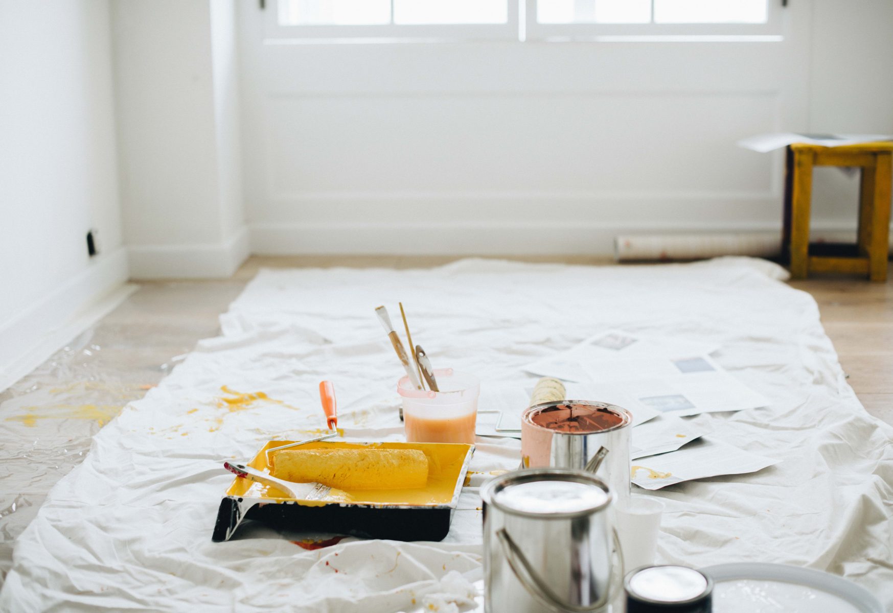 photo of painting tools and cans of paint - home renovation tips